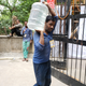 A worker brings water into the counting center for Delhi South.